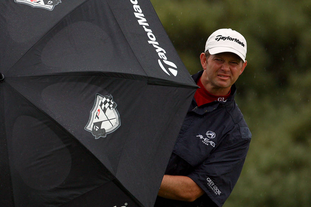 Retief Goosen peers out from an umbrella at Royal Birkdale in 2008